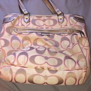 A tan cloth Coach purse